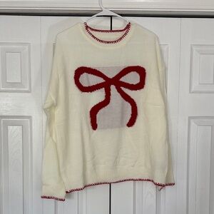 Elegant Cream Sweater with Red Bow Accent